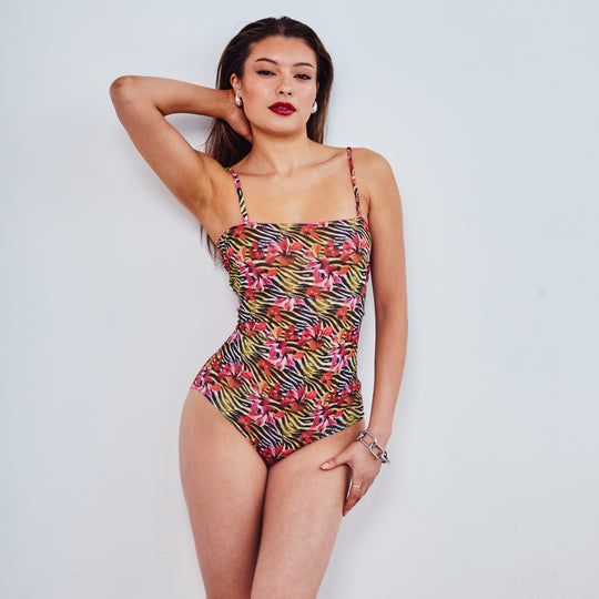 Girl in bandeau swimsuit with hand in hair