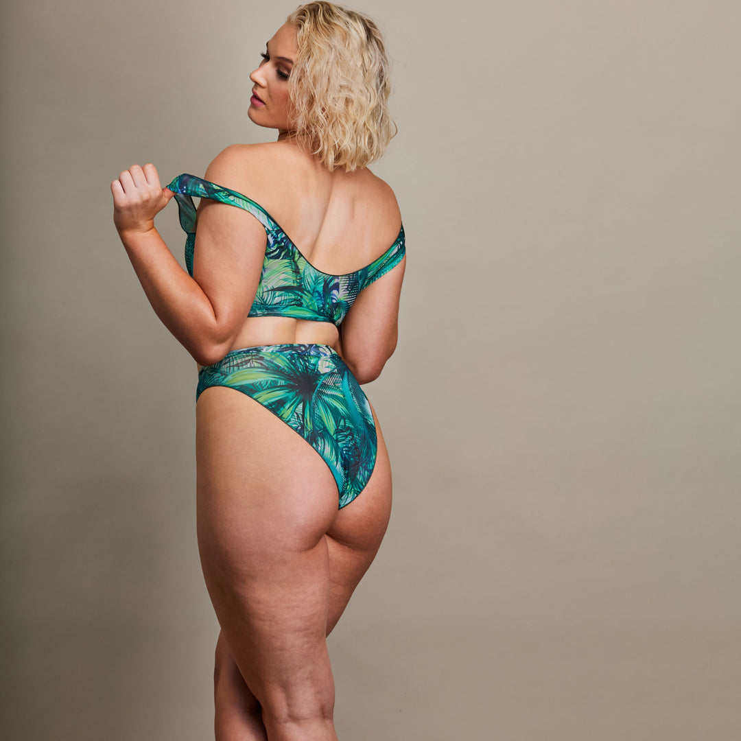 Girl showing us the back of green bikini